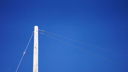electrical pole over blue sky