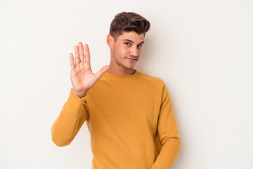 Young caucasian man isolated on white background rejecting someone showing a gesture of disgust.