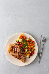 Pork entrecote on the bone with salad