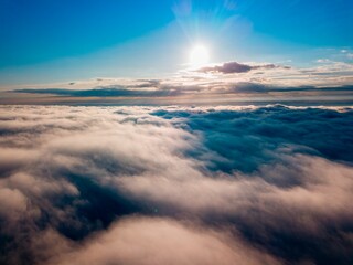 High flight over the fog in the mountains. Ukrainian Carpathians in the morning. Aerial drone view.