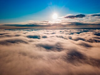 High flight over the fog in the mountains. Ukrainian Carpathians in the morning. Aerial drone view.
