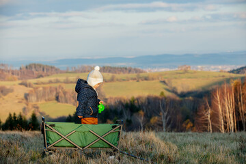 Little child in a wagon in the mountains © Masson