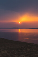 Coastline View of Sun Peaking Through Clouds in Mykonos Greece