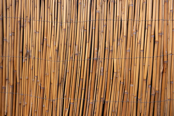 The image of the wall created with bamboos as the background