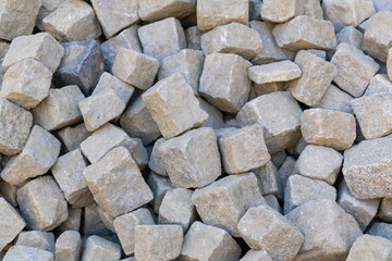 Cube-shaped cut paving stones are kept in the application area...