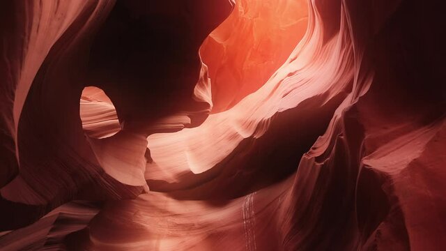 4K footage of cinematic red wavy pattern nature background from world famous landmark Antelope canyon in Arizona nature park, USA travel concept. Beautiful smooth wavy texture orange sandstone walls