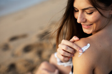 Woman using sunscreen cream. Beautiful girl with sun protection cream..