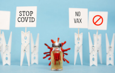 virus body and syringe with vaccine ampoule, concept of mass vaccination of the population against covid 19 Pro-Vaccine vs Anti-Vaccine problem