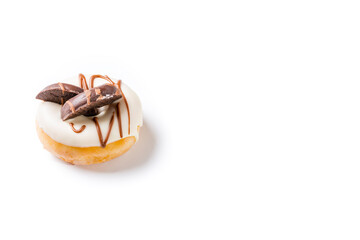 Photograph of a white chocolate donuts with dark chocolate cookies on a white background.The photo is shot in horizontal format and has copy space.
