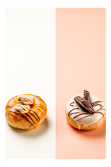 Photograph of two donuts decorated with cookies and drawn with chocolate.The photo is shot in portrait format and has a white frame around it.