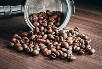 Portafilter with roasted beans on dark wood