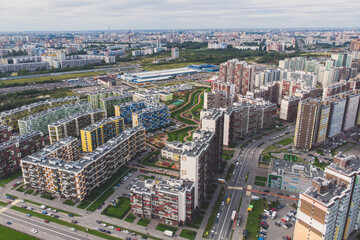 Fototapeta premium Aerial drone view of Kudrovo city skyline panorama, Saint-Petersburg outskirts, Leningrad oblast, Vsevolozhsky District high density living suburbia, high rise district area, Dybenko station, Russia
