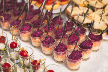 Catering table buffet dinner, beautifully decorated banquet with variety of different food snacks and appetizers on corporate birthday party event or wedding reception, canape, delicatessen setting