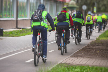 View of bicycle race in the city streets, bike race with a group mass of cyclist athletes in cycling competition, team of bikers on a urban bike path
