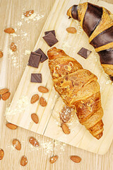 croissant on a table with chocolate and nuts