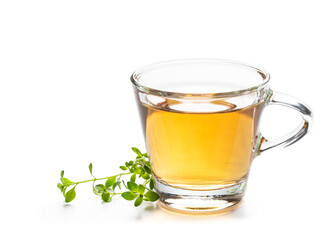 Green tea with lemon balm herb in glass cup isolated on white