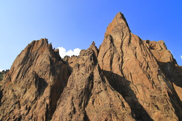 The rocks of the mountain against the blue sky. Suitable for interior, photo wallpapers, photo frames and lovers of mountain landscapes.