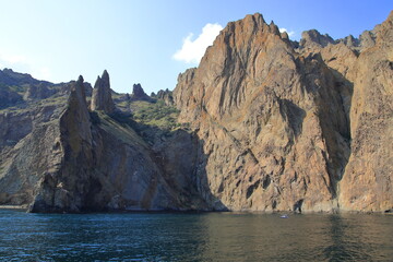 The cliffs of a high mountain on the seashore, calm and clear weather. Suitable for backgrounds, photo wallpapers and landscape lovers.