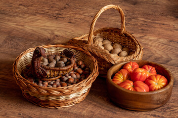 harvest of fresh tomatoes, hazelnuts and walnuts stacked on the floor