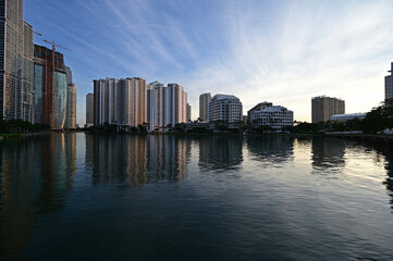 Obraz premium City of Miami, Florida skyline reflected in still water of Biscayne Bay at sunrise.
