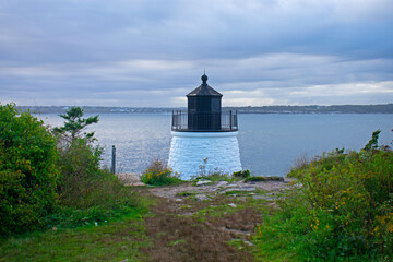 Fototapeta na wymiar Castle Hill lighthouse in Newport, Rhode Island, overlooking Narragansett Bay from a rocky shoreline -08