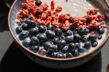 Berry mix bowl super food with healthy granola grain muesli in yogurt for breakfast food meal with honey blueberry strawberry