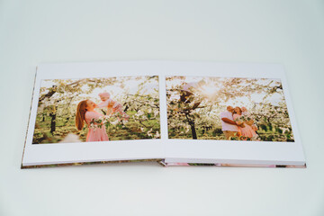 white background open photobook from family photo shoot in spring garden