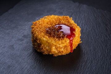 Breaded Camembert cheese with berry syrup