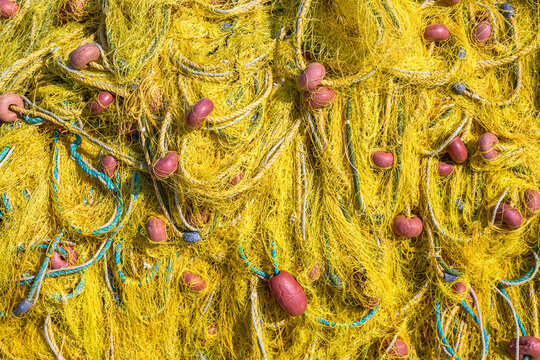 Close up macro image of old yellow fishing net.