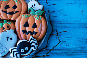 pumpkin gingerbread for halloween on blue wooden table