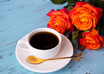 autumn mood coffee in a white cup, roses on a blue background