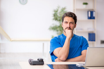 Young male doctor working in the clinic