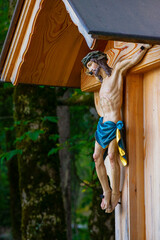 Catholic church and Jesus Christ on crucifix in the forest