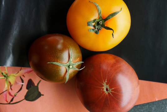 Heirloom tomato still life, fresh, colorful farmers market produce on collage background.