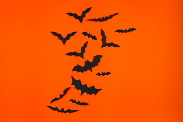 Happy Halloween. Paper bats on orange background.