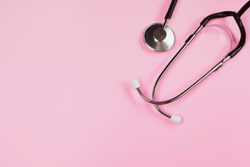 Stethoscope on pink background. Health care concept. Medical instrument for diagnosing diseases.