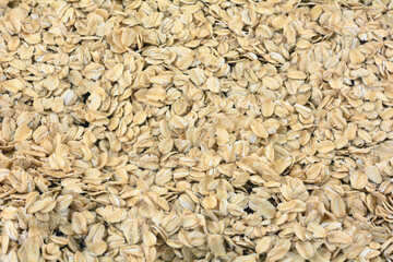 Food background of healthy traditional old fashioned roasted rolled oats grain