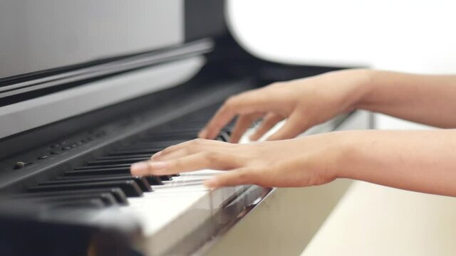 Elegant grand piano. A girl's hand comes and plays a piano