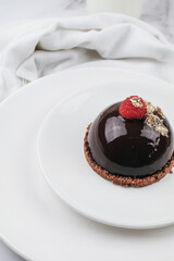 Chocolate mousse with fresh berries on marble table. Modern european desserts. Shallow focus