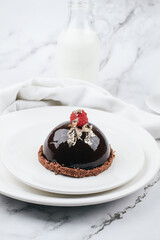Chocolate mousse with fresh berries on marble table. Modern european desserts. Shallow focus