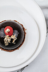 Obraz na płótnie Canvas Chocolate mousse with fresh berries on marble table. Modern european desserts. Shallow focus