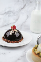 Chocolate mousse with fresh berries on marble table. Modern european desserts. Shallow focus