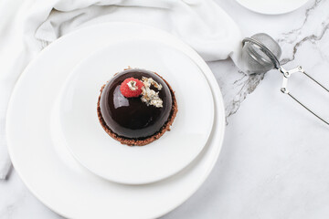 Chocolate mousse with fresh berries on marble table. Modern european desserts. Shallow focus