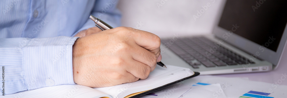 Poster hands of businessman calculate tax with calculator while laptop computer on desk, man planning finan
