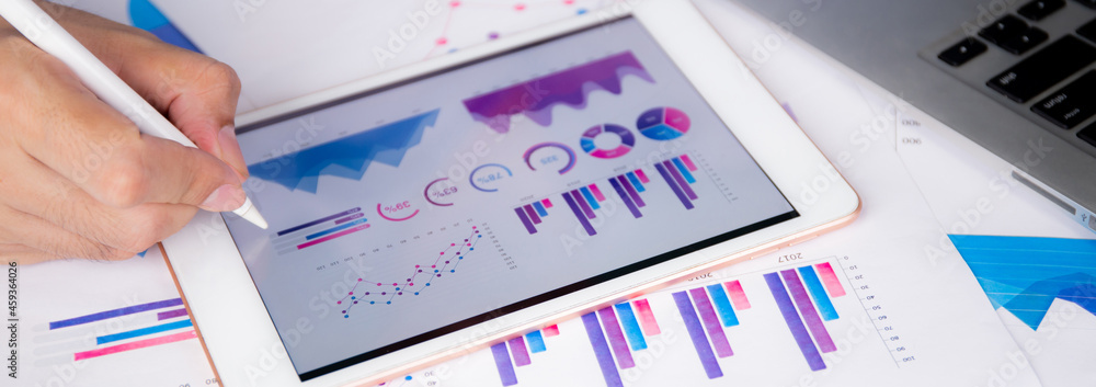Poster businessman planning about graph and chart of investment with report for finance on tablet computer 