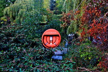 Lifebuoy next to pond in the Palace Garden, Buckingham Palace, London 