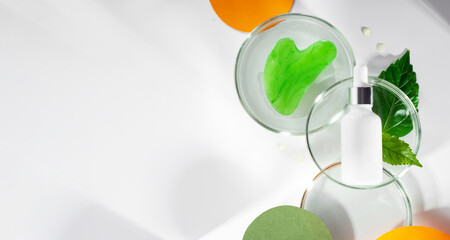 Polyglutamic acid, for deep hydration and facial skin care. Petri dishes with green leaf and water. Background with colored orange paper and shadows. Concept New beauty Anti age trend. Copy spase