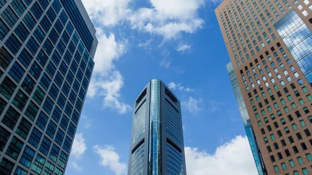Timelapse stock footage of clouds and blue sky with office buildings, Tokyo, Japan