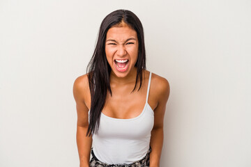 Young latin woman isolated on white background  shouting very angry, rage concept, frustrated.