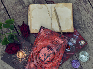 Still life with old decorated book with roses and crystals.